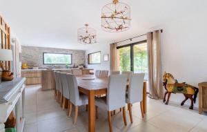 a kitchen and dining room with a wooden table and chairs at Maison Avec Piscine in La Roque-Esclapon
