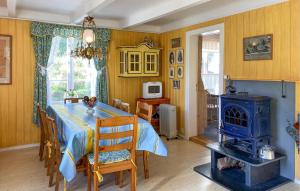 a dining room with a blue table and a stove at Beautiful Home In Vistdal With Wifi in Myklebostad