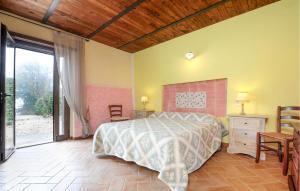 a bedroom with a bed and a large window at Pet Friendly Home In Acquasparta in Quadrelli