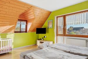 a bedroom with two beds and a tv in it at Ferienwohnung Lilly in Schwanau