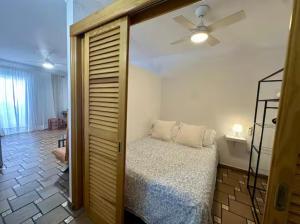 a bedroom with a bed and a ceiling fan at House with balcony and views of the Atlantic in El Pris in El Pris