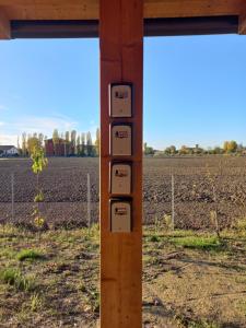 a control pole with a field in the background at Room & Breakfast Olmo Tondo in San Giovanni in Persiceto