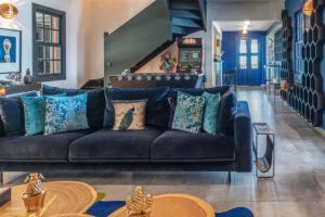 a living room with a black couch and blue walls at Sun-Soaked Haven With Caribbean Views in Gustavia