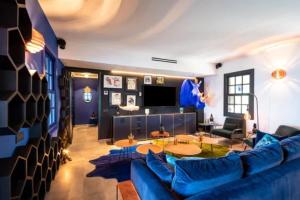 a living room with a blue couch and a table at Sun-Soaked Haven With Caribbean Views in Gustavia