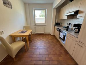 a small kitchen with a table and a table and a table and a table at Schöne Gästewohnung zum Erholen in Bad Sülze +5 photos