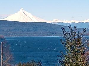 a view of a snow covered mountain and a lake at Cabañas Mantilhue Puyehue in Mantilhue