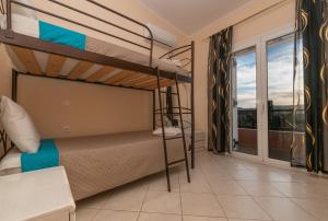 a bedroom with two bunk beds and a balcony at Agapi's Oasis Villa by "elite" in Akrotiri +48 photos