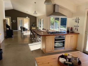 a kitchen with a table and a counter top at One Mile Bridge - Off Grid Stays in Mole Creek