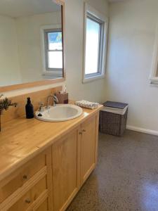 a bathroom with a sink and a mirror at One Mile Bridge - Off Grid Stays in Mole Creek