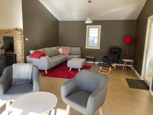 a living room with a couch and chairs and a table at One Mile Bridge - Off Grid Stays in Mole Creek +15 photos