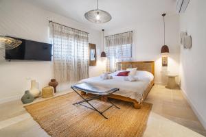 a bedroom with a bed and a chair in it at City of David - Boutique Stay by the Western Wall in Jerusalem