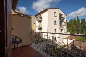 a balcony with a chair and a building at Piazza Grande-Giallo Cremisi in Arezzo