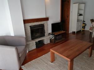 a living room with a couch and a fireplace at Esterri Confort in Esterri d'Àneu