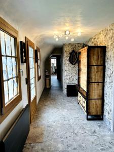 a hallway of a home with a door and windows at La Chaumière des 2 Cygnes-SPA- WIFI-Parking-Calme in Abbeville