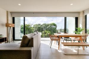 een open woonkamer met een tafel en stoelen bij Great location depto with Gym in Cancun