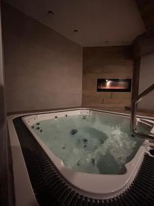 a jacuzzi tub in a room with aperature at Pensjonat Sekuła*** in Bukowina Tatrzańska