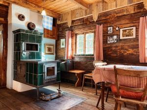 a kitchen with a stove and a table in a room at Turracher Hütte in Turracher Hohe