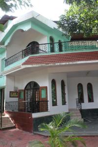 a house with a balcony on top of it at Shalom Dream Home in Candolim
