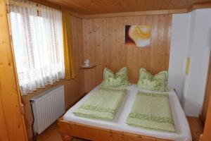a bedroom with two beds in a wooden room at Hoamatlhütte in Schladming
