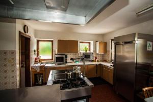 a kitchen with a stove and a stainless steel refrigerator at Hinterauhof in Rain