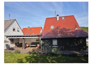 a house with red roofs and a patio at Haus Kerkyra in Dickesbach