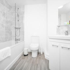 a white bathroom with a toilet and a shower at Two Bedrooms Apartment - Parking - Cradley Heath 51C in Netherton