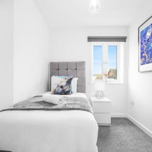 a white bedroom with a bed and a window at Two Bedrooms Apartment - Parking - Cradley Heath 51C in Netherton +11 photos