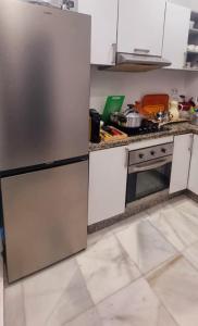 a kitchen with a stainless steel refrigerator and a stove at Appart Ennakhil 4 avenue mohamed 6 in El Jadida