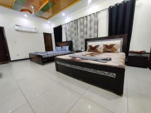 a bedroom with two beds in a room at Evergreen Lodge - Unmarried couples are not allowed in Rawalpindi