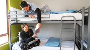 a man and a woman sitting on a bunk bed at European Hostel Central Pattaya in Pattaya Central