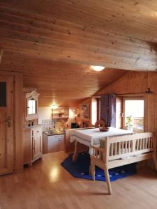 a kitchen with a large bed in the middle of a room at Chalet Luxeck in Steinberg am Rofan