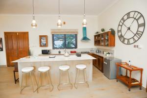 a kitchen with a large kitchen island with bar stools at Emerald Sunset Villa in Zanzibar City
