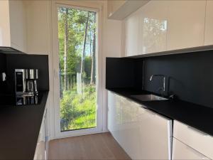 a kitchen with a sink and a window at Holiday home in the middle of nature in Knared in Eslared