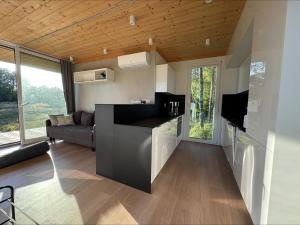 a kitchen and living room of a tiny house at Holiday home in the middle of nature in Knared in Eslared