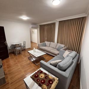 a living room with a couch and a table at Al-Farouq Suites in Amman