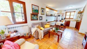 a living room with a couch and a table at Casa Las Tinajas in Alcalá de la Selva