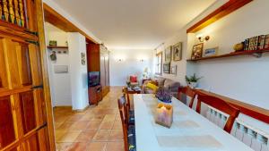 a living room with a table and a couch at Casa Las Tinajas in Alcalá de la Selva +57 photos