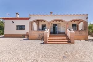 a house with a staircase in front of it at Villa Durán in Cantillana