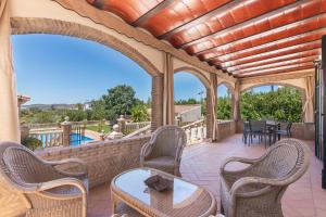 an outdoor patio with chairs and a table at Villa Durán in Cantillana