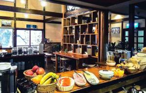 a kitchen with baskets of fruit on a table at Santana Lodge Hakuba in Hakuba