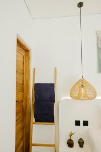 a room with a bed and a pendant light at Villas Tamu 1 in Bingin Beach