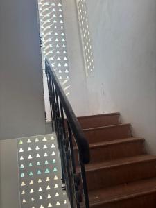 a set of stairs with a metal railing with lights at De beachside Villa in Virāmpattinam