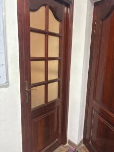 an open wooden door with a glass window at De beachside Villa in Virāmpattinam