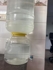 a glass jar with a yellow top with water inside at De beachside Villa in Virāmpattinam