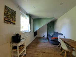 a living room with a blue couch and a table at Reload Apartments - FeWo3 im Remmeker Feld in Bad Arolsen