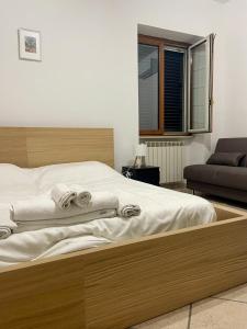 a bedroom with a large bed with towels on it at Carioca Aparthotel in Capua