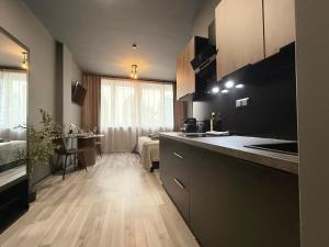 a kitchen with a counter and a room with a bed at M-Studio Apartments in Stuttgart Zentrum in Stuttgart