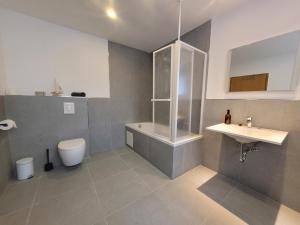 a bathroom with a toilet and a sink at Reload Apartments - FeWo3 im Remmeker Feld in Bad Arolsen