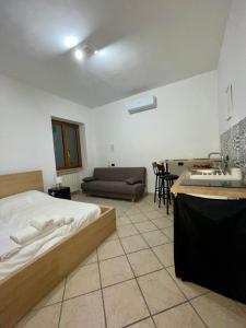 a bedroom with a bed and a living room at Carioca Aparthotel in Capua