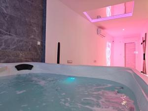 a bathroom with a jacuzzi tub with pink lighting at Secrets Torrevieja in Torrevieja